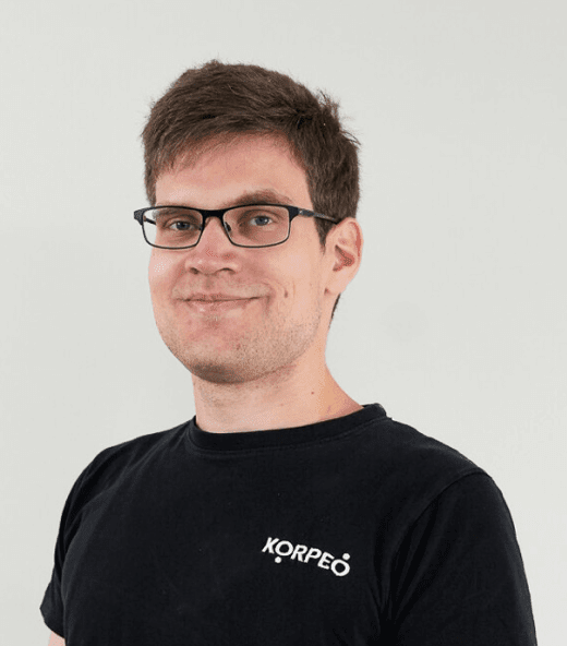 Lächelnder Mitarbeiter im Korpeo-T-Shirt – freundliches Teammitglied in der Physiotherapie.